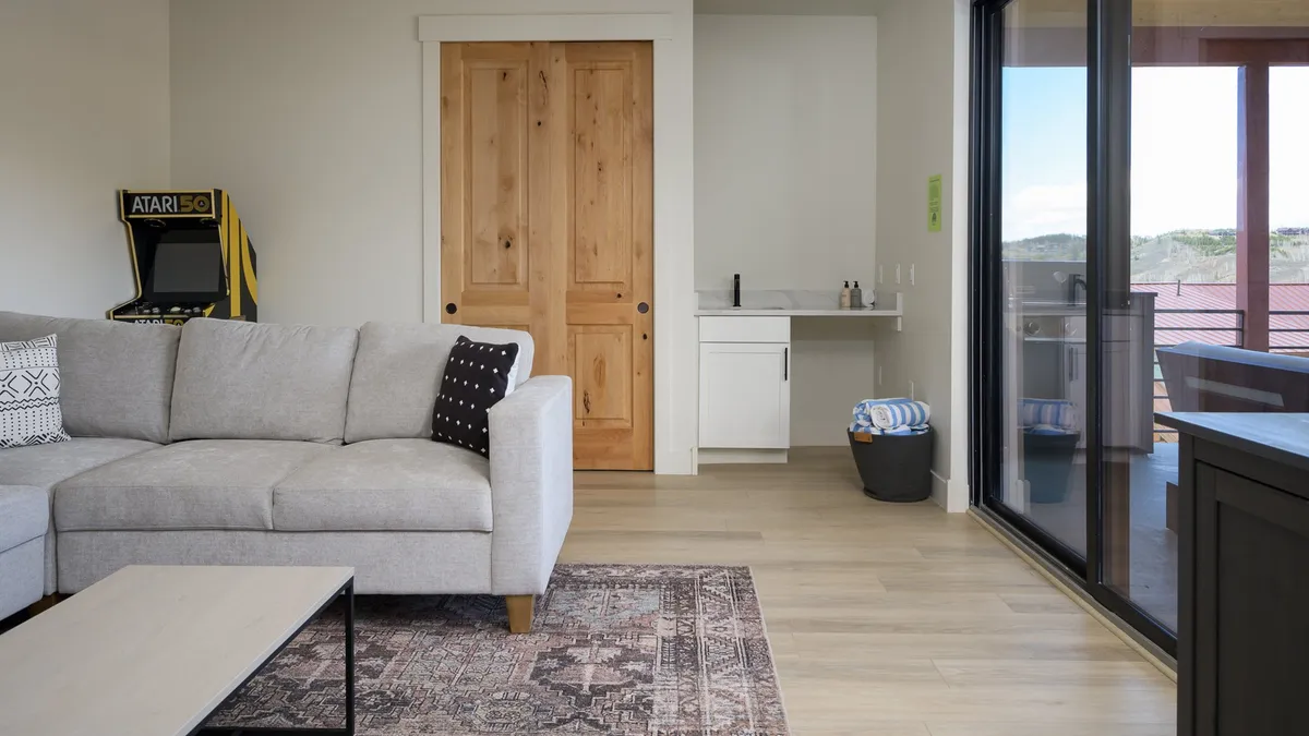 A comfortable lounge area with a sofa, visible Atari game console, and a casual, playful atmosphere. The space is designed for relaxation and entertainment, ideal for family game nights or unwinding after a day of adventure.